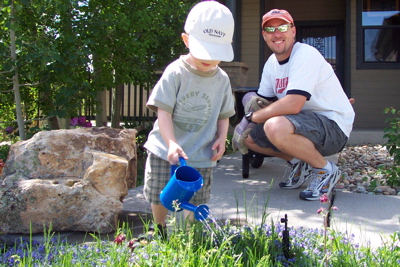 max_dad_frontyard_watering.JPG