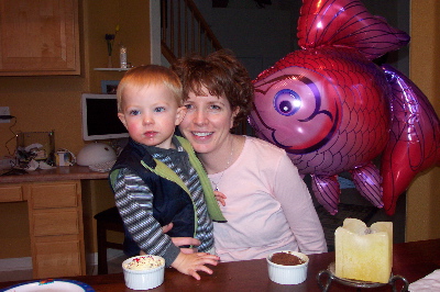 Max and Mom enjoy cupcakes, fish balloons and candles